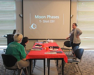 Neighbors | Jessica Harker .Librarian Amelia Dale hosted the Moon Phase Tshirt DIY project event at the Austintown library June 6.