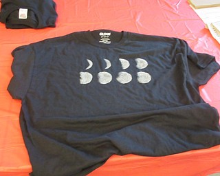 Neighbors | Jessica Harker .Librarian Amelia Dale created an example of a moon phase tshirt to show to community members gathered at the Austintown library June 6.
