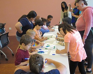 Neighbors | Jessica Harker .Childrens worked on earth themed crafts at the Michael Kusalaba library June 13.