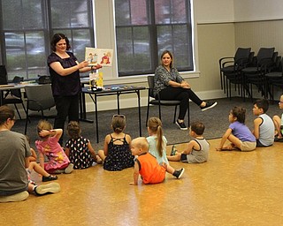 Neighbors | Abby Slanker.Amanda Kollar, assistant supervisor, youth librarian, played a recording of "If You Give a Mouse a Cookie," during which the children could follow along while she flipped through the story book at the Canfield library on July 6.