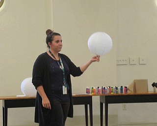 Neighbors | Jessica Harker.Librarian Renee Beverly demonstrated how to paint paper lanterns to look like a galaxy July 8 at the Austintown library.