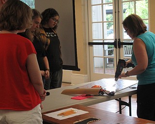 Neighbors | Jessica Harker .Using a heat gun Renee Beverly showed teenagers at the Poland library how to work with Worbla, a thermo plastic used in construction of cosplay armor on July 9.