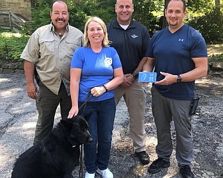 Neighbors | Submitted.The Busters Brigade donated a scanner to the Mill Creek Park police department as part of their ongoing project to donate chip scanners to local police forces.