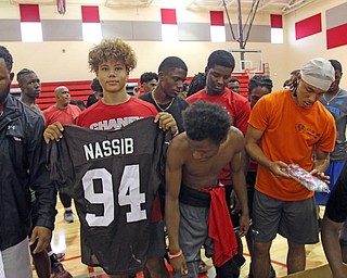  ROBERT K.YOSAY  | THE VINDICATOR..Cleveland Browns officials visited...Chaney High School - girard.. and one other school to make a donation to the CowboysÕ football and ..Christian Jones.. sophomore.. checks out a jersey