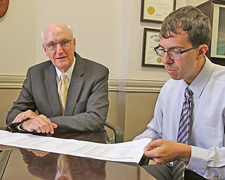 Mahoning County Auditor Ralph Meacham and staff accountant Alex Mangie review a spreadsheet that summarizes financial statistics for all 14 public school districts in Mahoning County.
