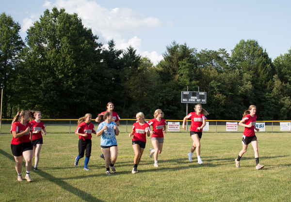 The Canfield-Poland softball team, who will be playing in the Junior League Softball World Series in Washington on Sunday, run at the beginning of practice at McCune Park on Wednesday. EMILY MATTHEWS | THE VINDICATOR