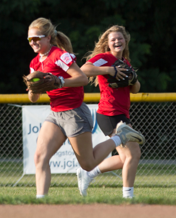 Alaina Scavina fields the ball while Alaina Frances runs behind her to back her up as they practice with their Canfield-Poland softball team, who will be playing in the Junior League Softball World Series in Washington on Sunday. EMILY MATTHEWS | THE VINDICATOR