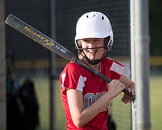 Emily Denney talks with her Canfield-Poland softball teammates, who will be playing in the Junior League Softball World Series in Washington on Sunday, as she waits to bat during practice at McCune Park on Wednesday. EMILY MATTHEWS | THE VINDICATOR