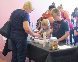 Neighbors | Jessica Harker .Children and their families went from station to station working on different crafts at the Michael Kusalaba library June 10.