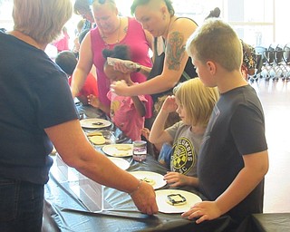 Neighbors | Jessica Harker .Children decorated sugar cookies to look like constelations June 10 at the Michael Kusalaba library.