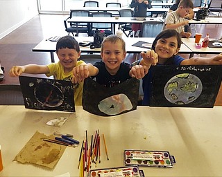 Neighbors | Submitted.Hudson Burnett, Alex Sich and Ava Burnett showed off their different planet designs at the Michael Kusalaba library June 10.