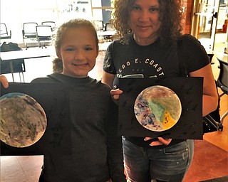 Neighbors | Submitted.Zariyah Ayala and her mother, Maribel Alam, showed off their water color planets at the Michael Kusalaba library on June 10.