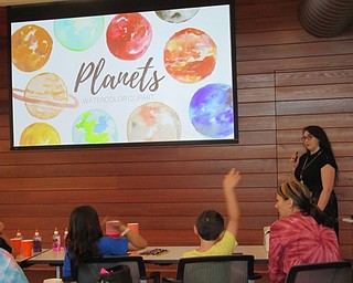 Neighbors | Jessica Harker .Hannah Matulek, a librarian assistant at the Michael Kusalaba branch, taught children about the science behind the colors of the planets at the first Water Color Planet making event.
