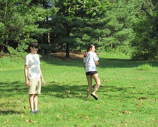 Neighbors | Jessica Harker .Teenagers threw frisbees back and forth practicing for Boardman Park's new Disc Golf Camp on June 27.
