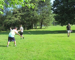 Neighbors | Jessica Harker .Children warmed up for Disc Golf Camp by playing catch with frisbees at the Boardman Park on June 27.