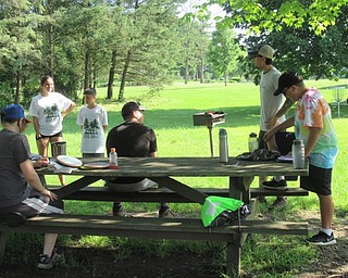 Neighbors | Jessica Harker .A group of teenagers listened to Justin Edwards with the Mahoning Valley Disc Golf Association, give instructions on the camp's daily activity at Boardman Park.