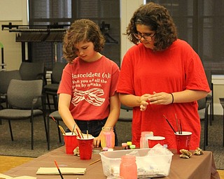 Neighbors | Abby Slanker.Analise and Mariska Petrycki (right) of Poland created glow in the dark jars at the Canfield library on June 29.