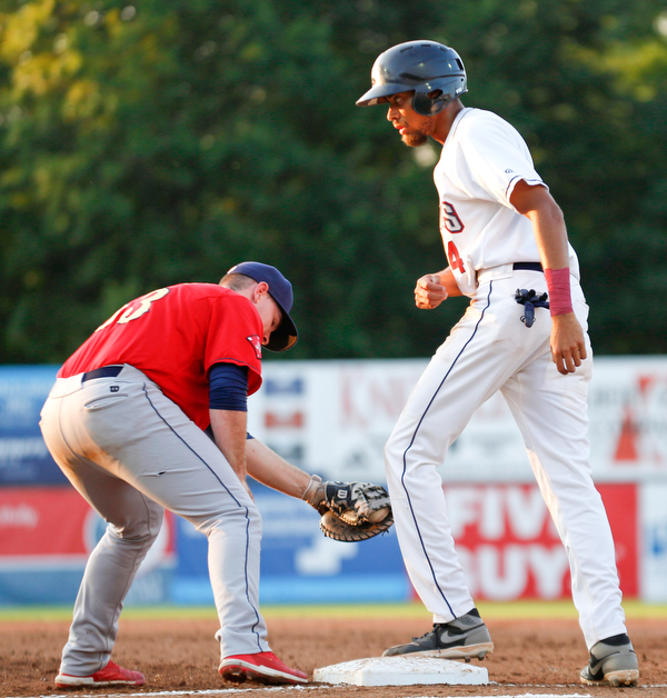 Scrappers' Michael Cooper gets back to first before Spikes' Brylie Ware could tag him during their game at Eastwood Field on Thursday night. EMILY MATTHEWS | THE VINDICATOR