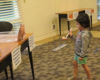 Neighbors | Jessica Harker .Children attempted to balance plastic eggs on spoons and walk them to a plastic bin at the Austintown library's Toy Box Takeover event on June 20.