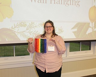 Neighbors | Abby Slanker.Adult Librarian Assistant Taylor Swan helped adults and teens create rainbow wall hangings for their homes on June 24.