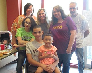 Neighbors | Jessica Harker .Junior Micah Beckwith, surrounded by his family, enjoyed dinner at Carmella's Cafe during the fundraising event on July 14 to raise money for a new racing chair for him before the next track season.