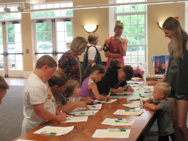 Neighbors | Jessica Harker .Children and their families gathered at the Poland library for the Green Team's visit from Mother Earth.