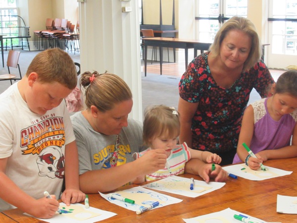 Neighbors | Jessica Harker .Children colored door hangers to look like the earth at the Poland library's Green Team event.