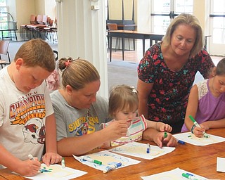 Neighbors | Jessica Harker .Children colored door hangers to look like the earth at the Poland library's Green Team event.