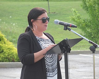 Neighbors | Jessica Harker .Quaker Steak and Lube Director Rachel Meszaros spoke at a dedication ceremony at the Austintown location where six benches dedicated to local fallen soliders and flags honoring all branches of the US military were erected.