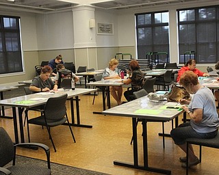 Neighbors | Abby Slanker.Adult and teen participants let their creative juices flow as they make hand-sewn pouches for electronics at the Canfield library.