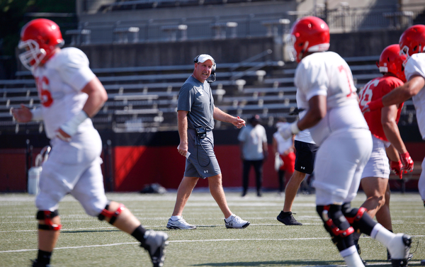 Head Coach Bo Pelini talks to his team during YSU's scrimmage Saturday morning at Stambaugh Stadium. EMILY MATTHEWS | THE VINDICATOR