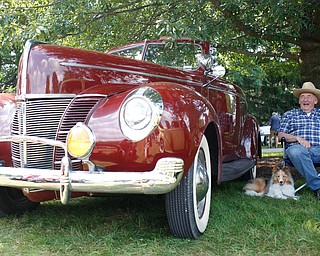 Clyde Foor, of Poland, sits next to his original 1944 Ford Deluxe with his Sheltie Piper at the 41st annual Cars in the Park car show in Boardman Park on Sunday afternoon. Proceeds from the car show will go to Harper, Foley, 4, who has Dravet Syndrome, a catastrophic form of epilepsy. EMILY MATTHEWS | THE VINDICATOR