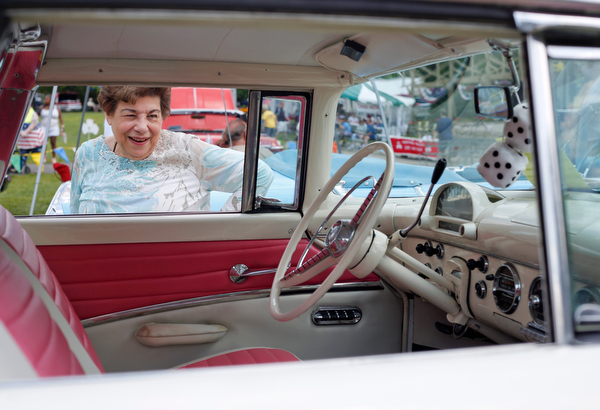Mary Jo Herrholtz, of Niles, looks at the inside of a Ford Fairlane Crown Victoria at the 41st annual Cars in the Park car show in Boardman Park on Sunday afternoon. Proceeds from the car show will go to Harper, Foley, 4, who has Dravet Syndrome, a catastrophic form of epilepsy. EMILY MATTHEWS | THE VINDICATOR