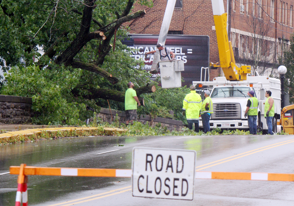 William D. Lewis the vindicator Warren City crews work at removing  downed tree on hte West Mrket St Bridge i in Warren after fast moving storm hit Tuesday 8-6-19 afternoon.