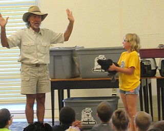 Neighbors | Jessica Harker .Jungle Terry gave volunteer Vanessa a chicken named chicky to hold during his performance at the Austintown library.