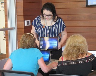 Neighbors | Jessica Harker .Hannah Matulek, a librarian at the Michael Kusalaba library, instructed community members on how to select #D designed for the Outer Space Jewlery making event on July 10..