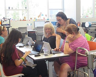 Neighbors | Jessica Harker .Community members worked on laptops to create space themed pendant designs to print using the Michael Kusalaba library's 3D printer July 10.