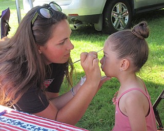 Neighbors | Jessica Harker .Volunteers from the Olde Car Club painted Danyah Mustafa's face at their annual car show in Boardman Park.