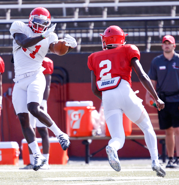 London Pearson catches the ball as Devanere Crenshaw (2) runs up to him during YSU's scrimmage on Saturday. EMILY MATTHEWS | THE VINDICATOR