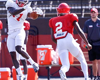 London Pearson catches the ball as Devanere Crenshaw (2) runs up to him during YSU's scrimmage on Saturday. EMILY MATTHEWS | THE VINDICATOR