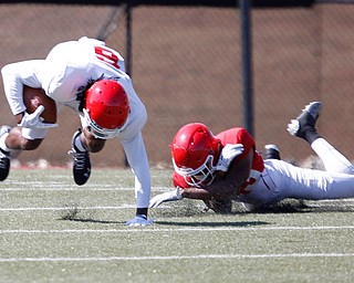 Melvin Jackson, right, tries to tackle Kendric Mallory as Mallory runs with the ball during YSU's scrimmage on Saturday. EMILY MATTHEWS | THE VINDICATOR