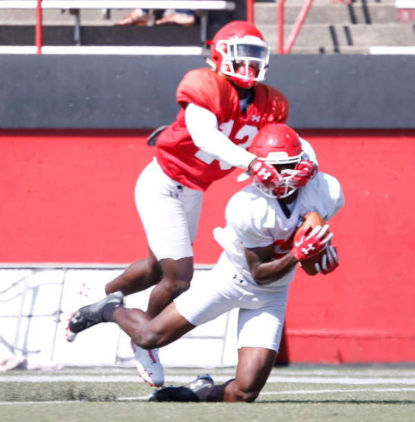 C.J. Charleston holds on to the ball as Dee Ford tackles him during YSU's scrimmage on Saturday. EMILY MATTHEWS | THE VINDICATOR