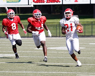 London Pearson runs with the ball to make a touchdown while Jaylen Hewlett (45) and Ray Anderson (8) chase him during YSU's scrimmage on Saturday. EMILY MATTHEWS | THE VINDICATOR