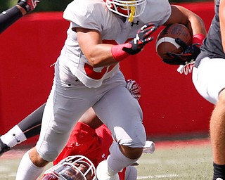 Randy Smith runs with the ball while Ray Anderson falls to the ground as he tries to tackle him during YSU's scrimmage on Saturday. EMILY MATTHEWS | THE VINDICATOR