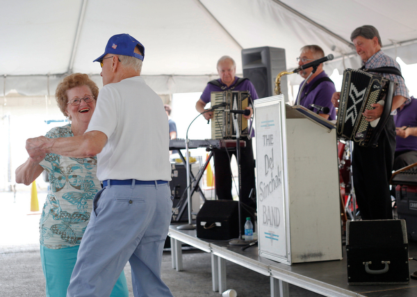 Pat Wagner and Joe Nemastil, both of Canton, dance while the Del Sinchak Band performs at the Slovak Fest at Byzantine Center at the Grove on Sunday afternoon. EMILY MATTHEWS | THE VINDICATOR