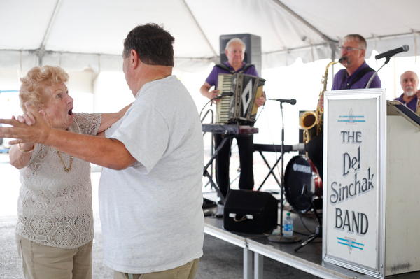Olga Spontak, of Zanesville, who recently celebrated her 90th birthday, and Rick Schen, of Canton, dance while the Del Sinchak Band performs at the Slovak Fest at Byzantine Center at the Grove on Sunday afternoon. Spontak and Schen are friends who dance polka together. EMILY MATTHEWS | THE VINDICATOR