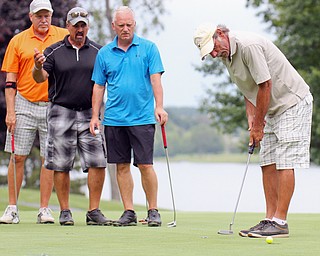 William D. Lewis Steve richman sinks a putt on #18 as from left: Blase Cindric, Scott Russell Doug Bleggi look on during Greatest Golfer Scramble at the Lake Club 8-12-19.