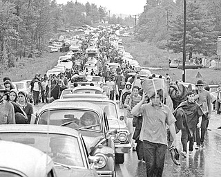 In this Aug. 16, 1969, file photo, hundreds of rock music fans jam a highway leading from Bethel, N.Y., as they try to leave the Woodstock Music and Art Festival. More than 400,000 people attended Woodstock, which was staged 80 miles northwest of New York City on a bucolic hillside owned by dairy farmer Max Yasgur. 