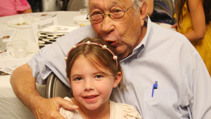 Sam Kooperman shares a moment with his great-granddaughter Mara Kooperman, 5, of Columbus during the Life Stories Project at the Jewish Community Center in Youngstown. Kooperman and 10 other local residents had their life stories told in book form, and they were honored Monday night.