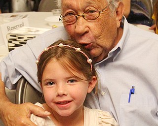 Sam Kooperman shares a moment with his great-granddaughter Mara Kooperman, 5, of Columbus during the Life Stories Project at the Jewish Community Center in Youngstown. Kooperman and 10 other local residents had their life stories told in book form, and they were honored Monday night.